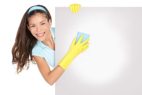 Professional cleaner preparing a modern Canary Wharf property